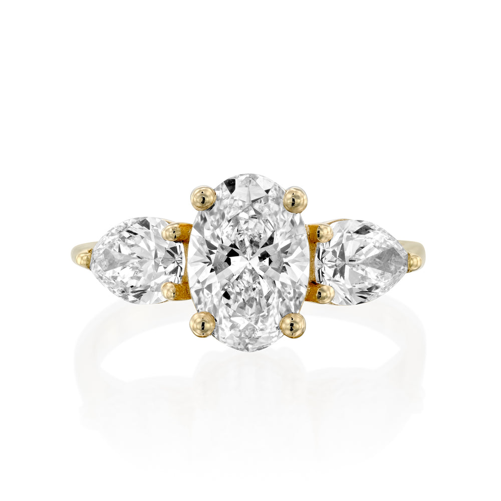 טבעת מזהב צהוב משובצת ביהלום אובלי מרכזי ושני יהלומים בצורת טיפה מסביבו